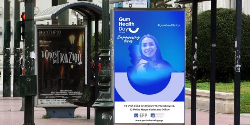 Bus stop with Gum Health Day poster in Greece