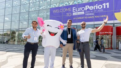 Three men and tooth in front of EP11 banner