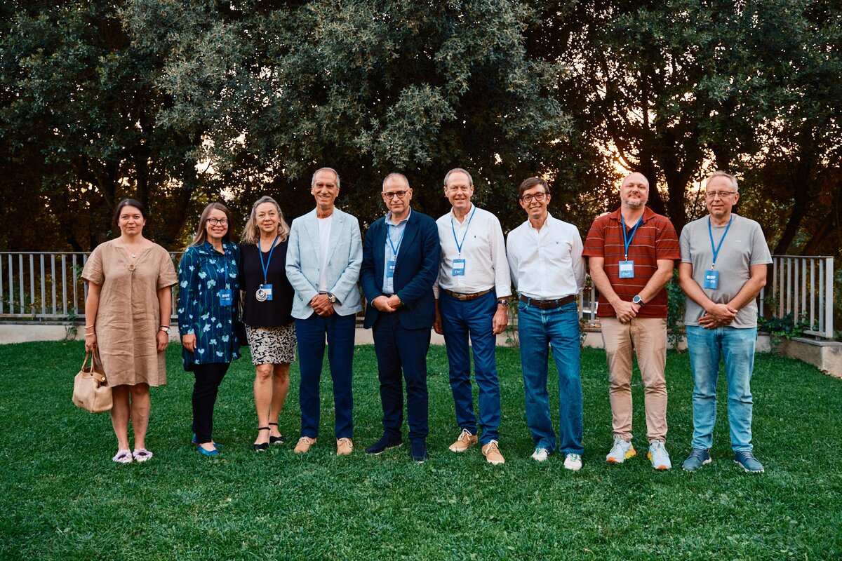 photo of committee members standing on lawn