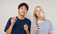photo of a man smoking and a woman vaping